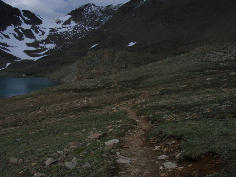 the trail heads past curator lake and up.