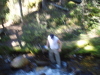 Blurred action shot as newbie slips on rocks getting water